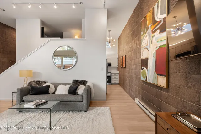 a living room with furniture and a mirror