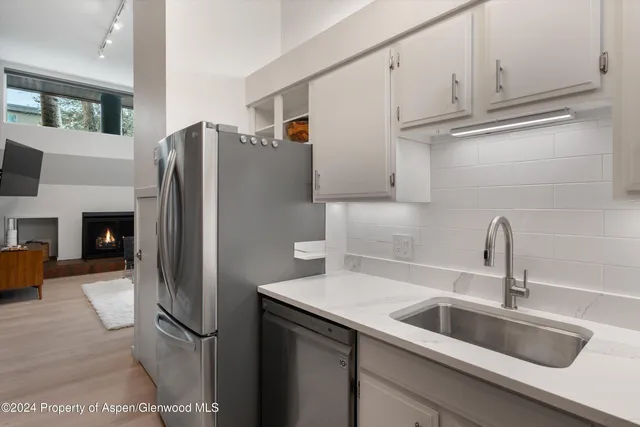 a kitchen with stainless steel appliances a refrigerator and a sink