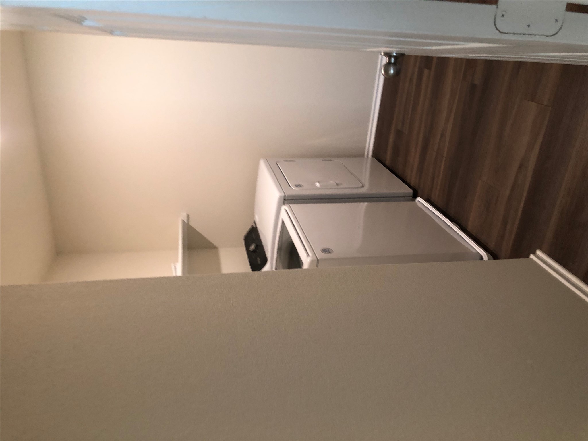 130 Lt Rusty Drive Jarrell, TX 76537 - Photo 11 of 13 Second floor utility room with vinyl plank flooring and convenient laundry appliances.