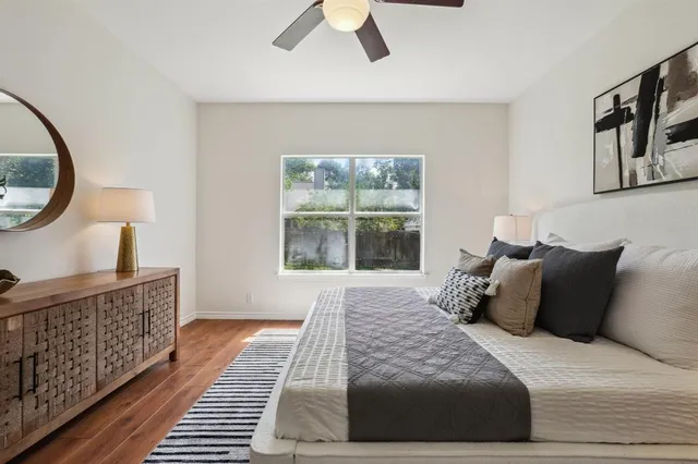 a large bed sitting in a bedroom next to a window