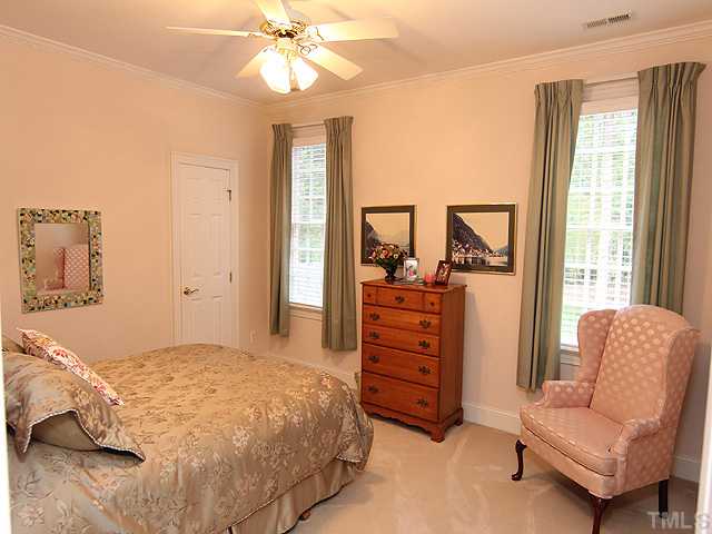 11216 Brass Kettle Road Raleigh, NC 27614 - Photo 14 of 25 a bedroom with a bed and ceiling fan