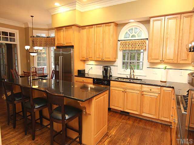 11216 Brass Kettle Road Raleigh, NC 27614 - Photo 8 of 25 a kitchen with stainless steel appliances a sink stove and refrigerator