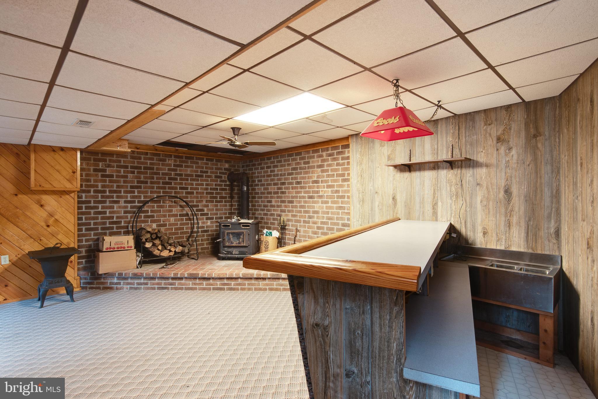 340 Witmer Road Mohnton, PA 19540 - Photo 26 of 35 Family room with wood burning stove and bar