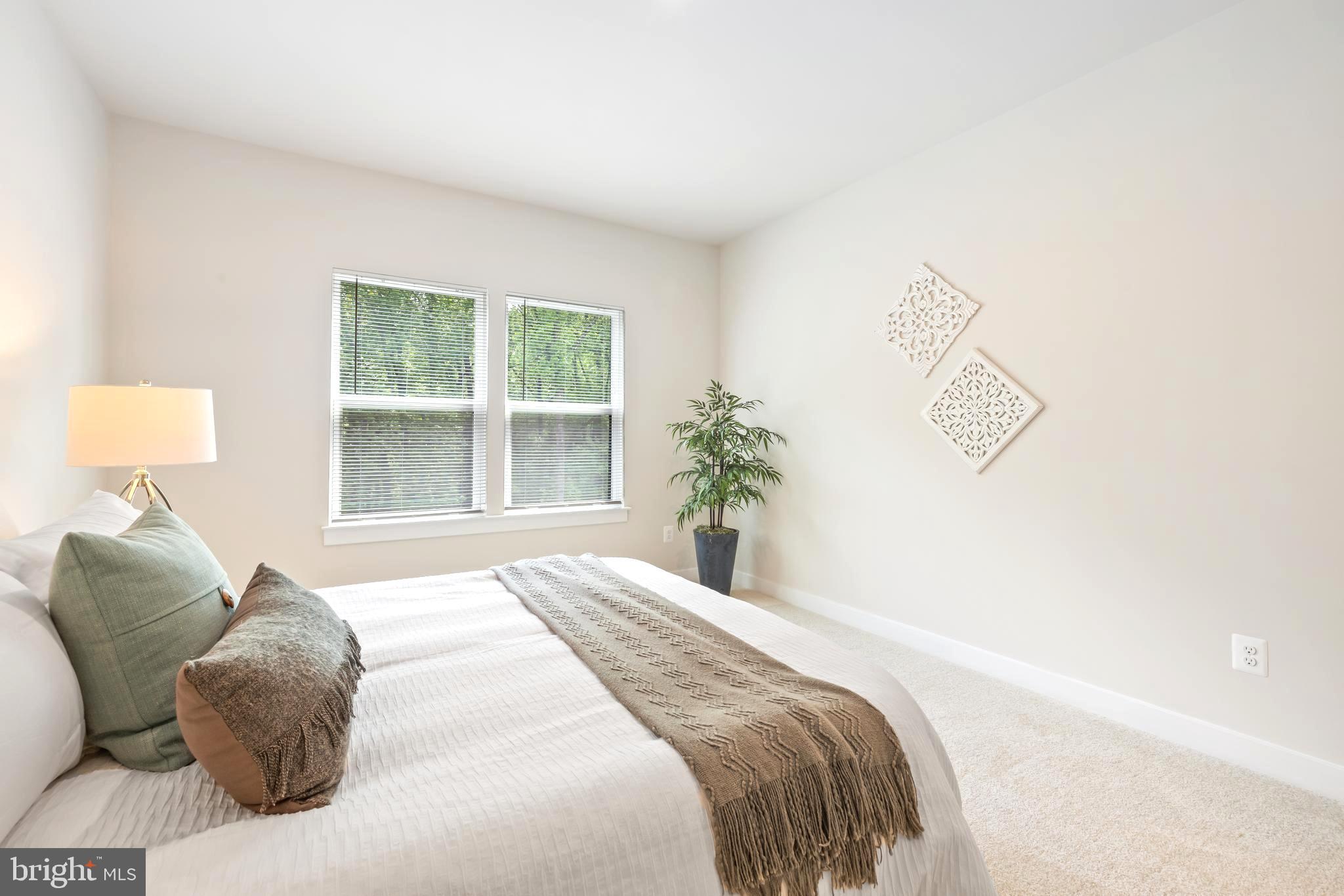 10391 Resort Road, Unit Q Ellicott City, MD 21042 - Photo 13 of 24 a bedroom with a bed and a window