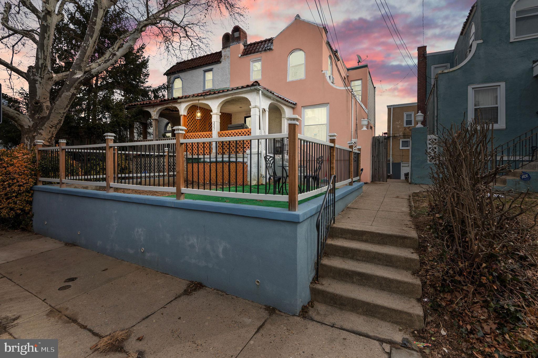 a view of a house with a small yard next to a road