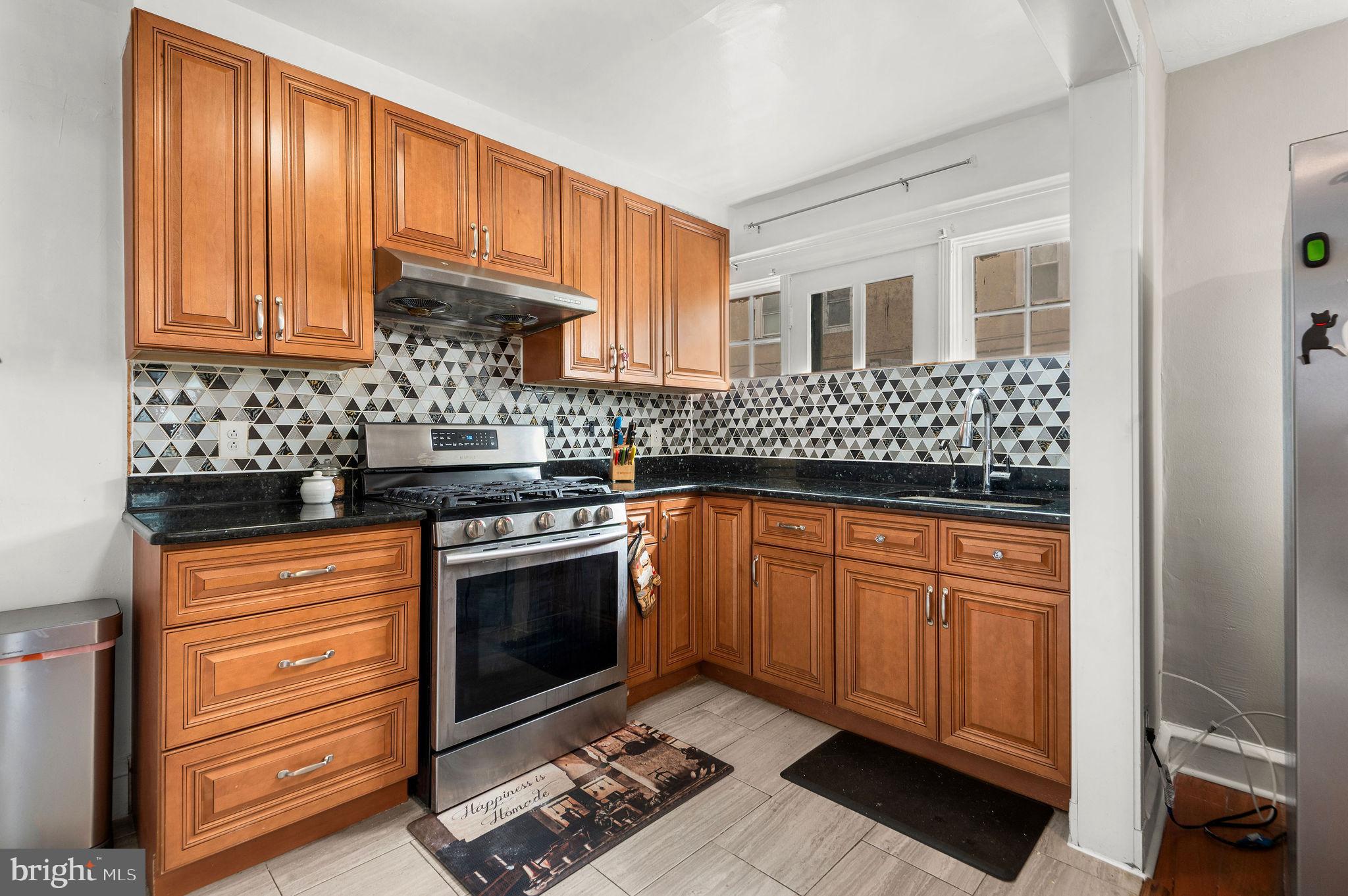 227 Shirley Road Upper Darby, PA 19082 - Photo 12 of 25 a kitchen with stainless steel appliances granite countertop a stove a sink and a refrigerator