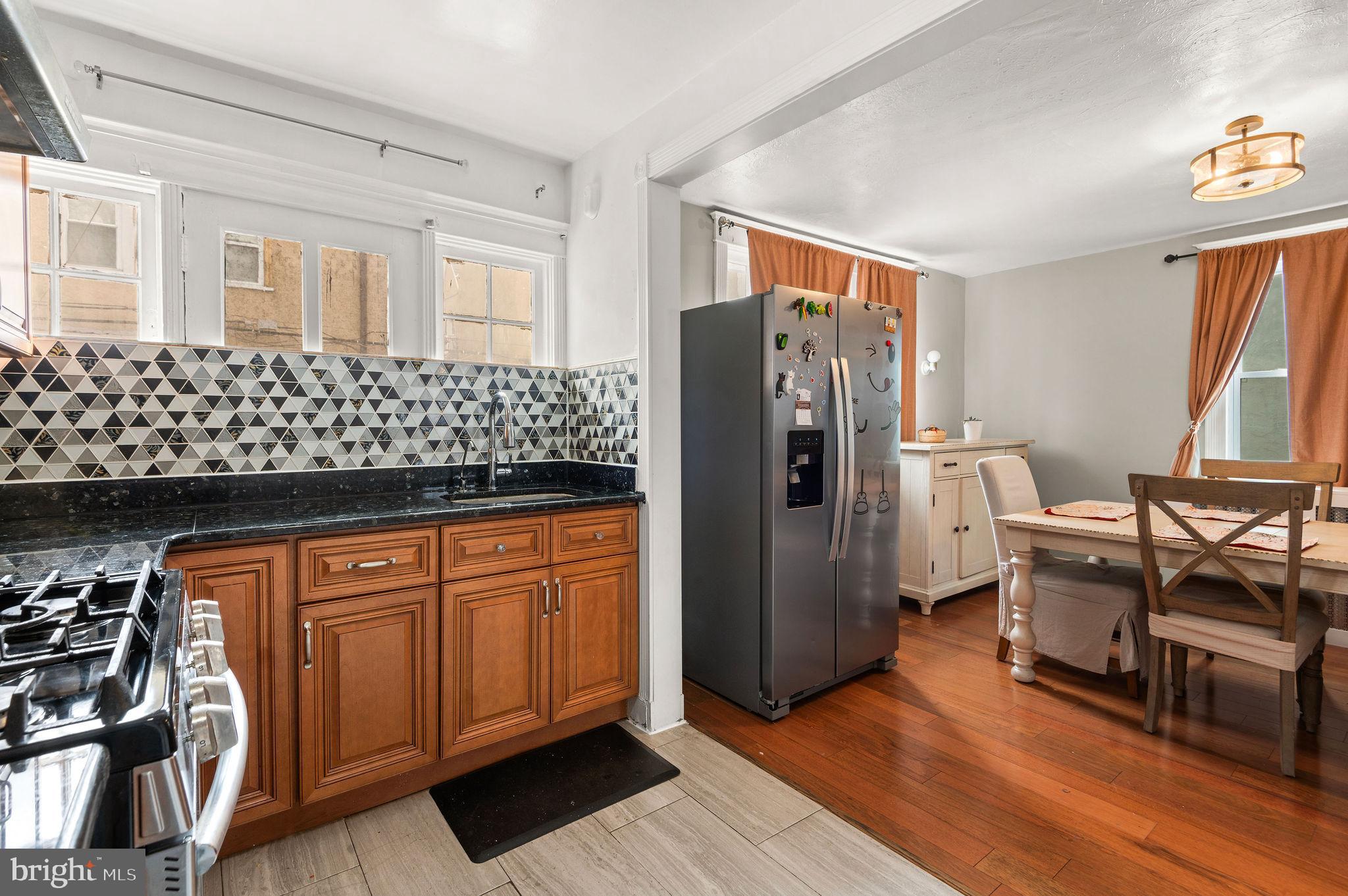 227 Shirley Road Upper Darby, PA 19082 - Photo 13 of 25 a view of a kitchen with refrigerator and wooden floor