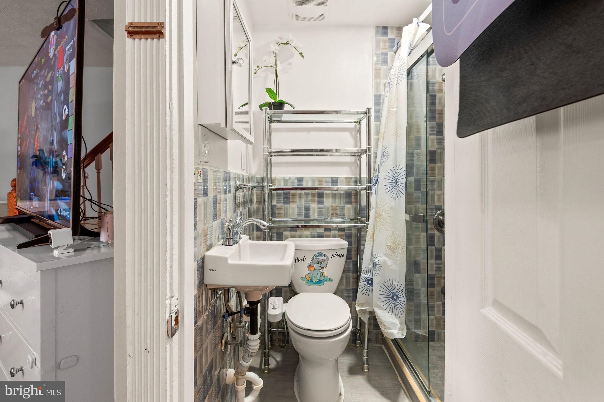 227 Shirley Road Upper Darby, PA 19082 - Photo 14 of 25 a bathroom with a toilet and a shower