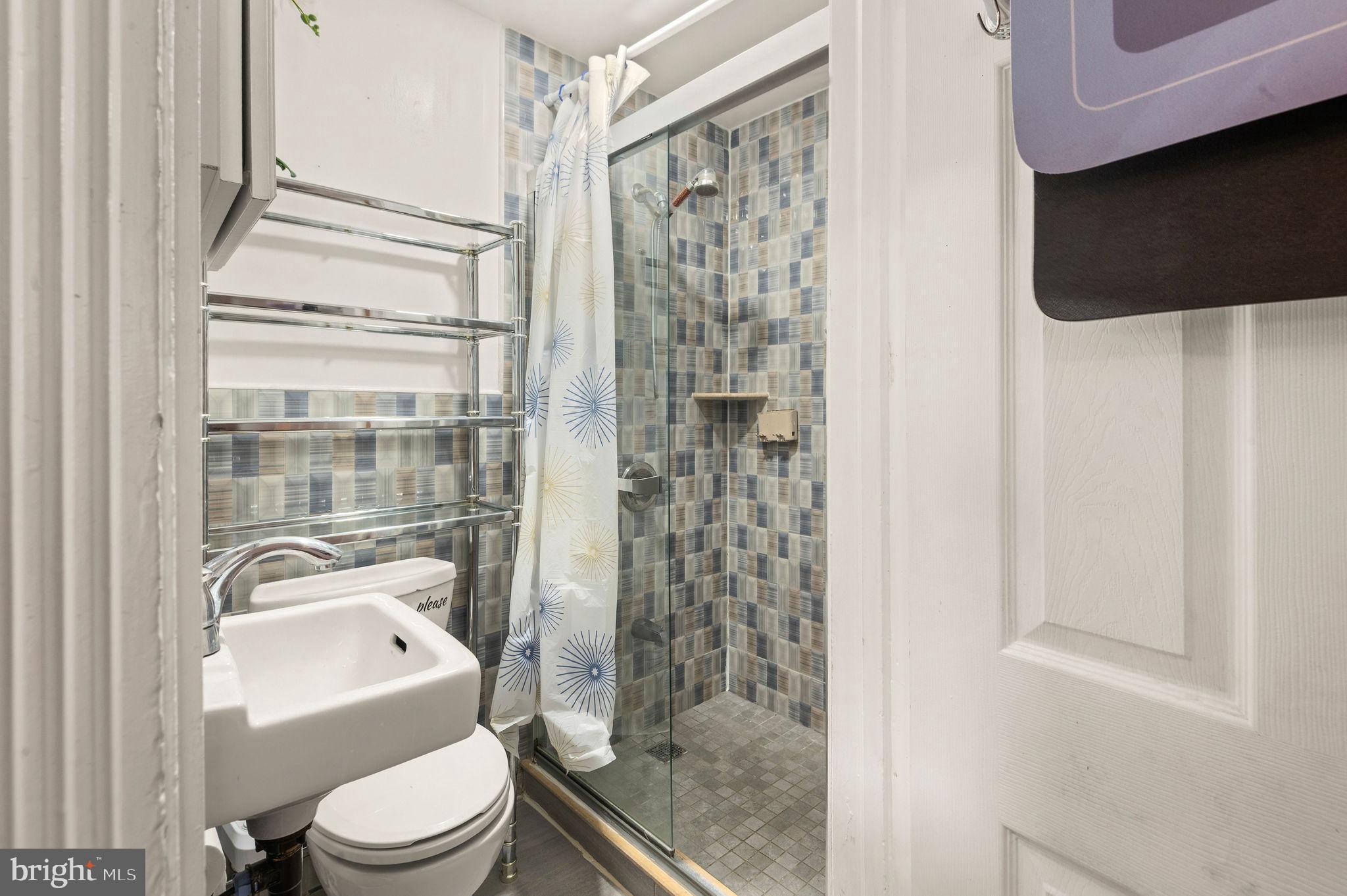 227 Shirley Road Upper Darby, PA 19082 - Photo 15 of 25 a bathroom with a toilet a sink and a shower