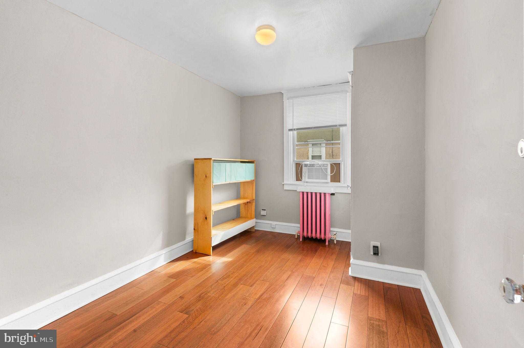 227 Shirley Road Upper Darby, PA 19082 - Photo 16 of 25 an empty room with wooden floor and windows