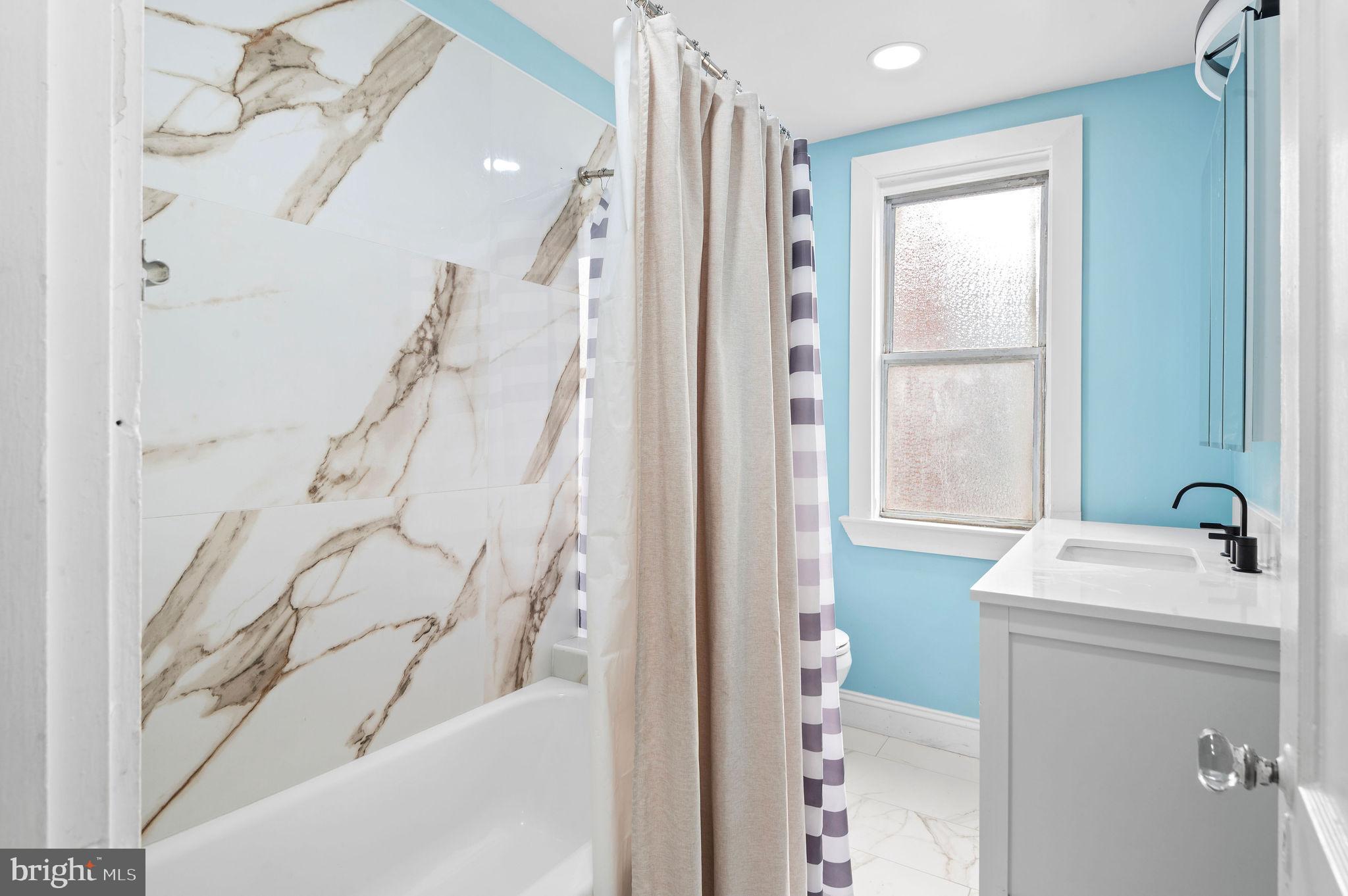 227 Shirley Road Upper Darby, PA 19082 - Photo 18 of 25 a bathroom with a sink a vanity and a shower