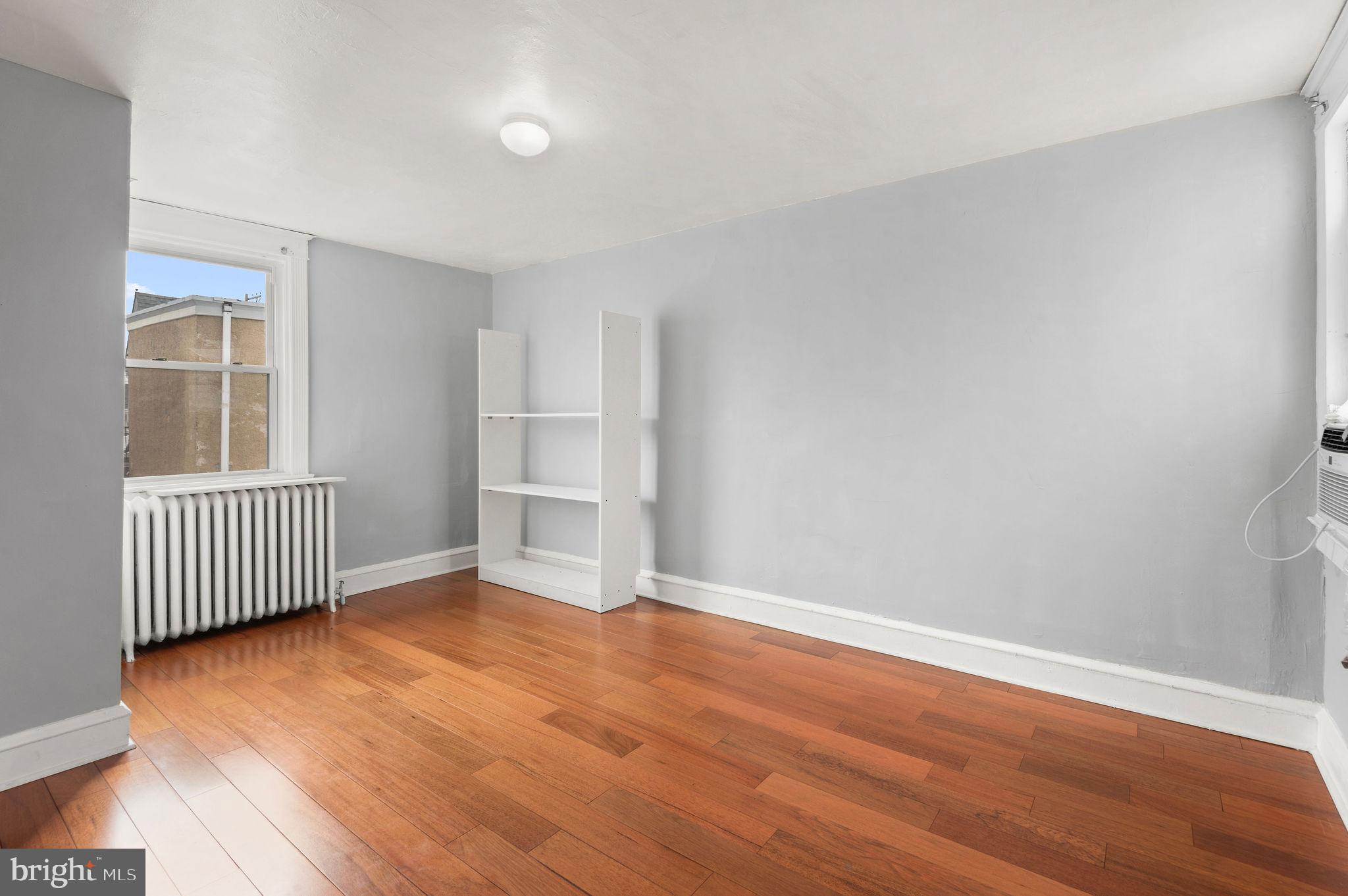 227 Shirley Road Upper Darby, PA 19082 - Photo 20 of 25 a view of empty room with wooden floor and fan