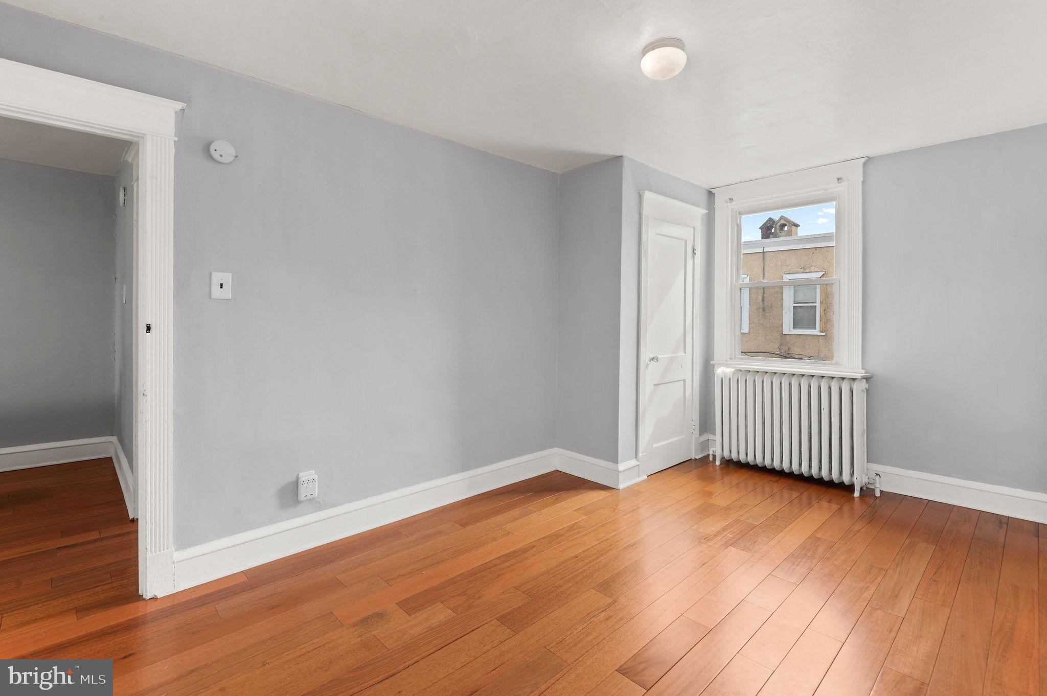 227 Shirley Road Upper Darby, PA 19082 - Photo 21 of 25 an empty room with wooden floor and windows