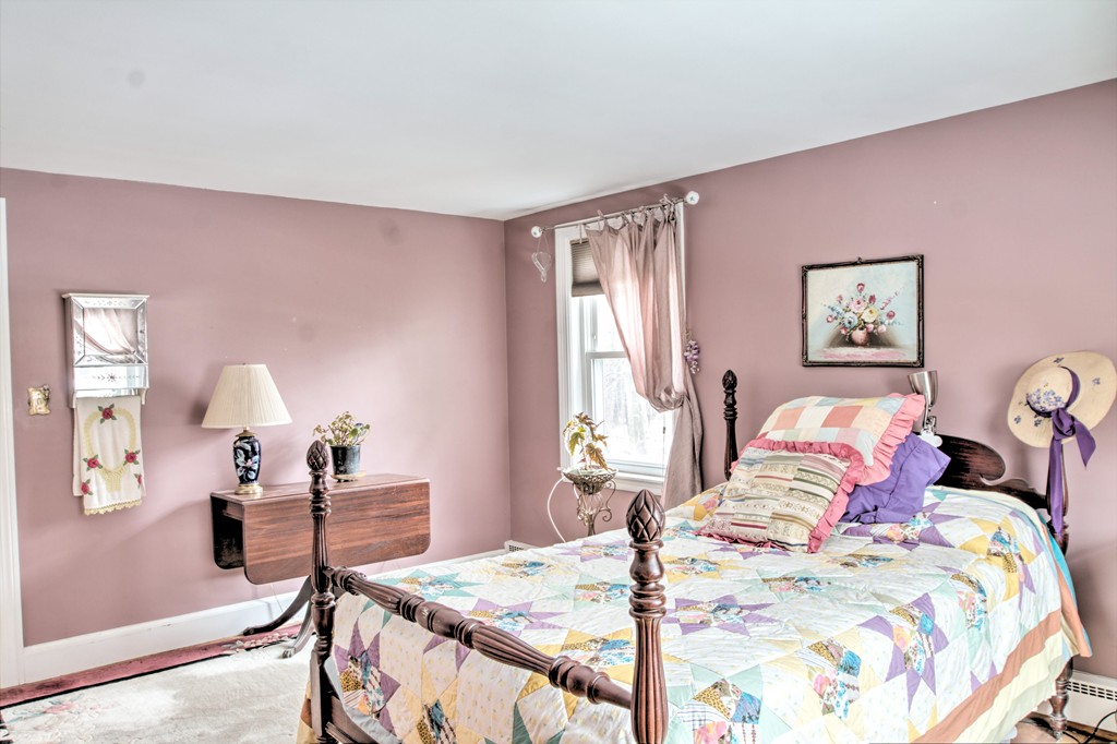 24 Hall Road Chelmsford, MA 01824 - Photo 14 of 30 a bedroom with a bed and a table in it