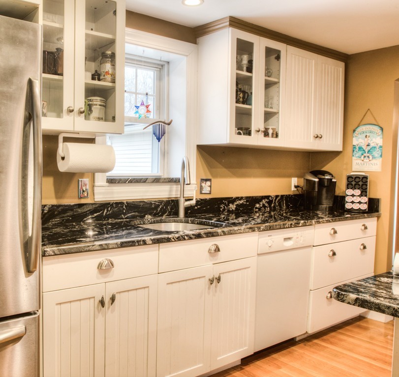 24 Hall Road Chelmsford, MA 01824 - Photo 19 of 30 a kitchen with stainless steel appliances granite countertop a stove and white cabinets
