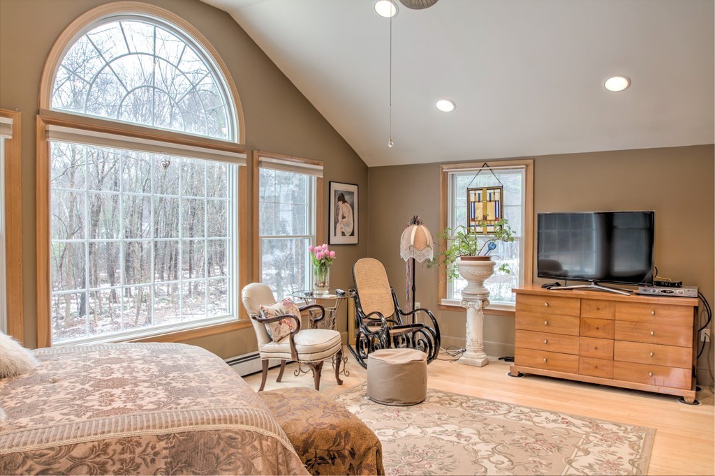 24 Hall Road Chelmsford, MA 01824 - Photo 5 of 30 a living room with furniture a flat screen tv and floor to ceiling windows