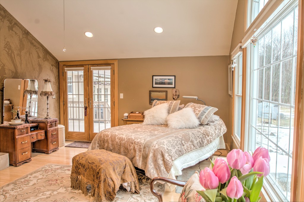 24 Hall Road Chelmsford, MA 01824 - Photo 6 of 30 a bedroom with a bed and large windows