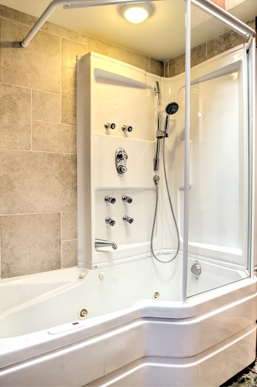 24 Hall Road Chelmsford, MA 01824 - Photo 8 of 30 a bathroom with a bathtub and shower