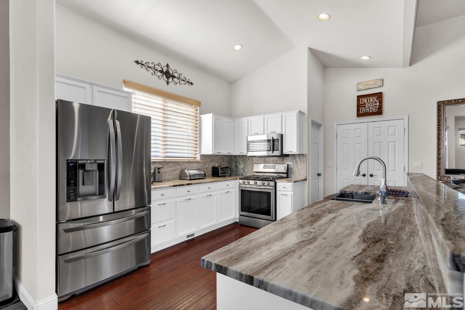 740 Silver Run Drive Reno, NV 89521 - Photo 11 of 36 a kitchen with granite countertop stainless steel appliances and wooden cabinets