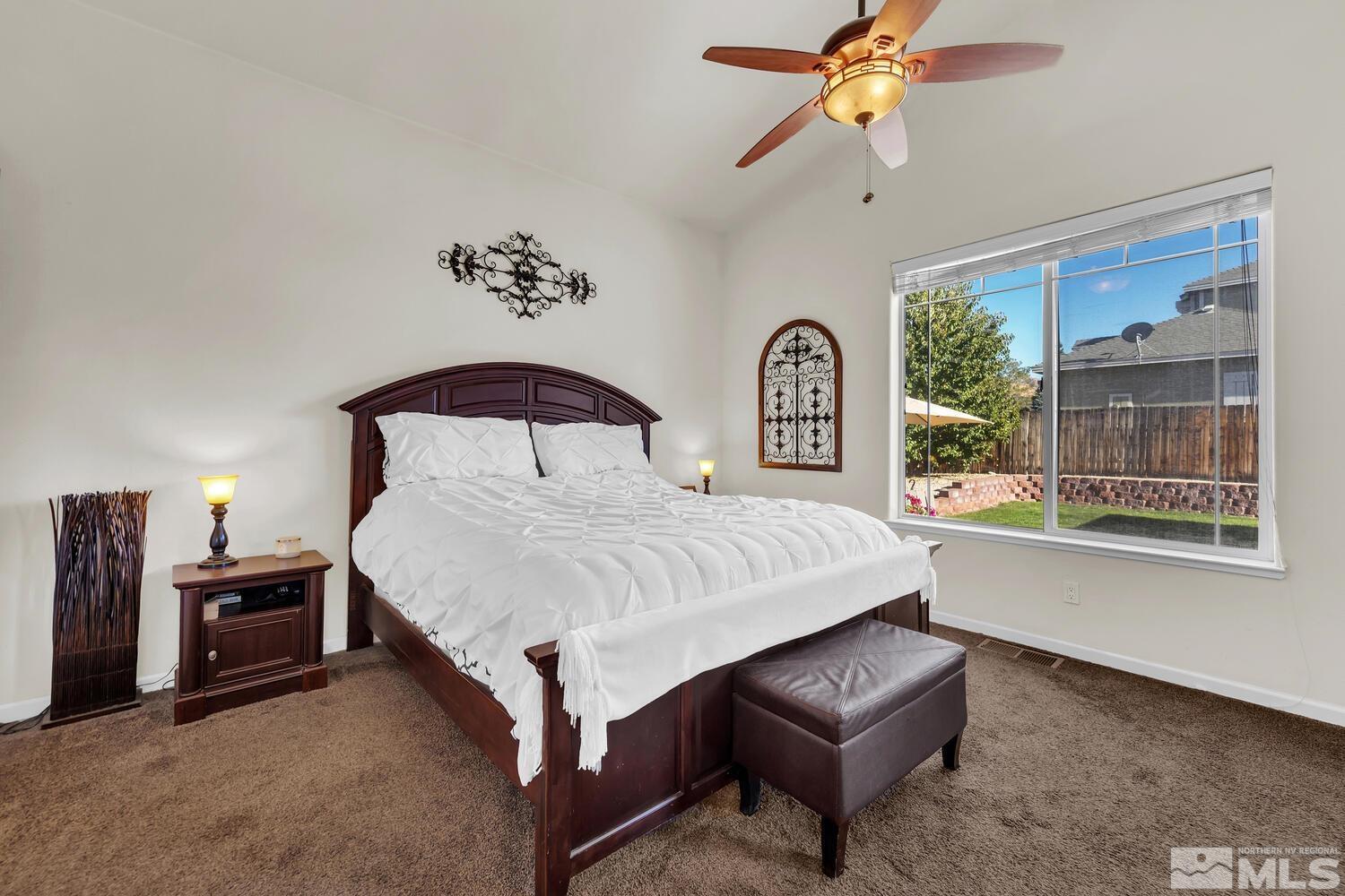 740 Silver Run Drive Reno, NV 89521 - Photo 15 of 36 a bedroom with a bed and a chandelier