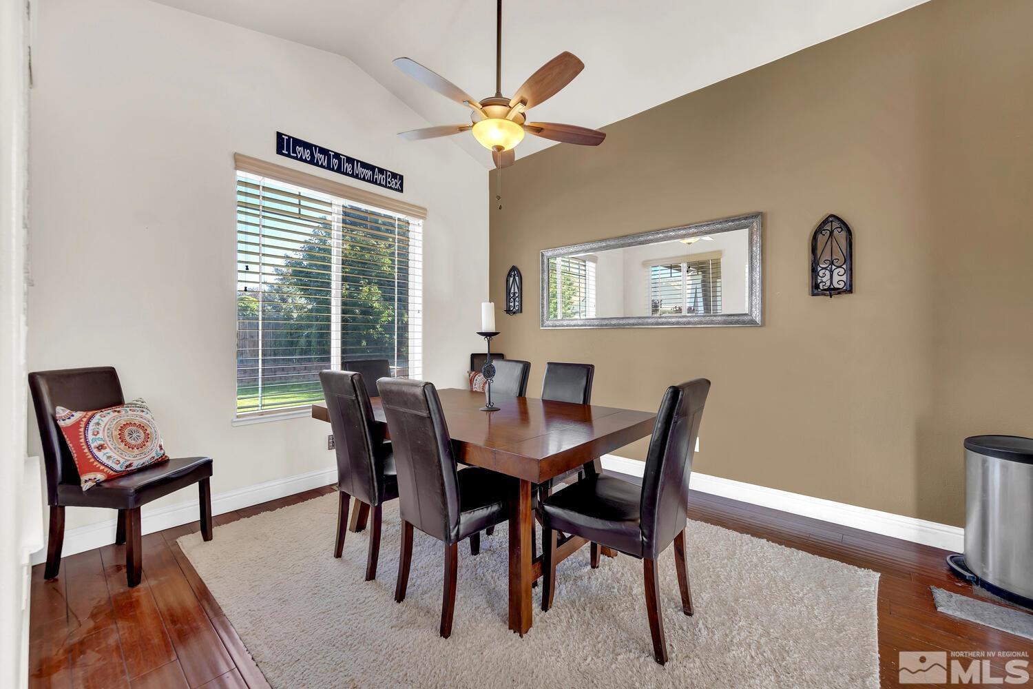 740 Silver Run Drive Reno, NV 89521 - Photo 6 of 36 a view of a dining room with furniture and a chandelier