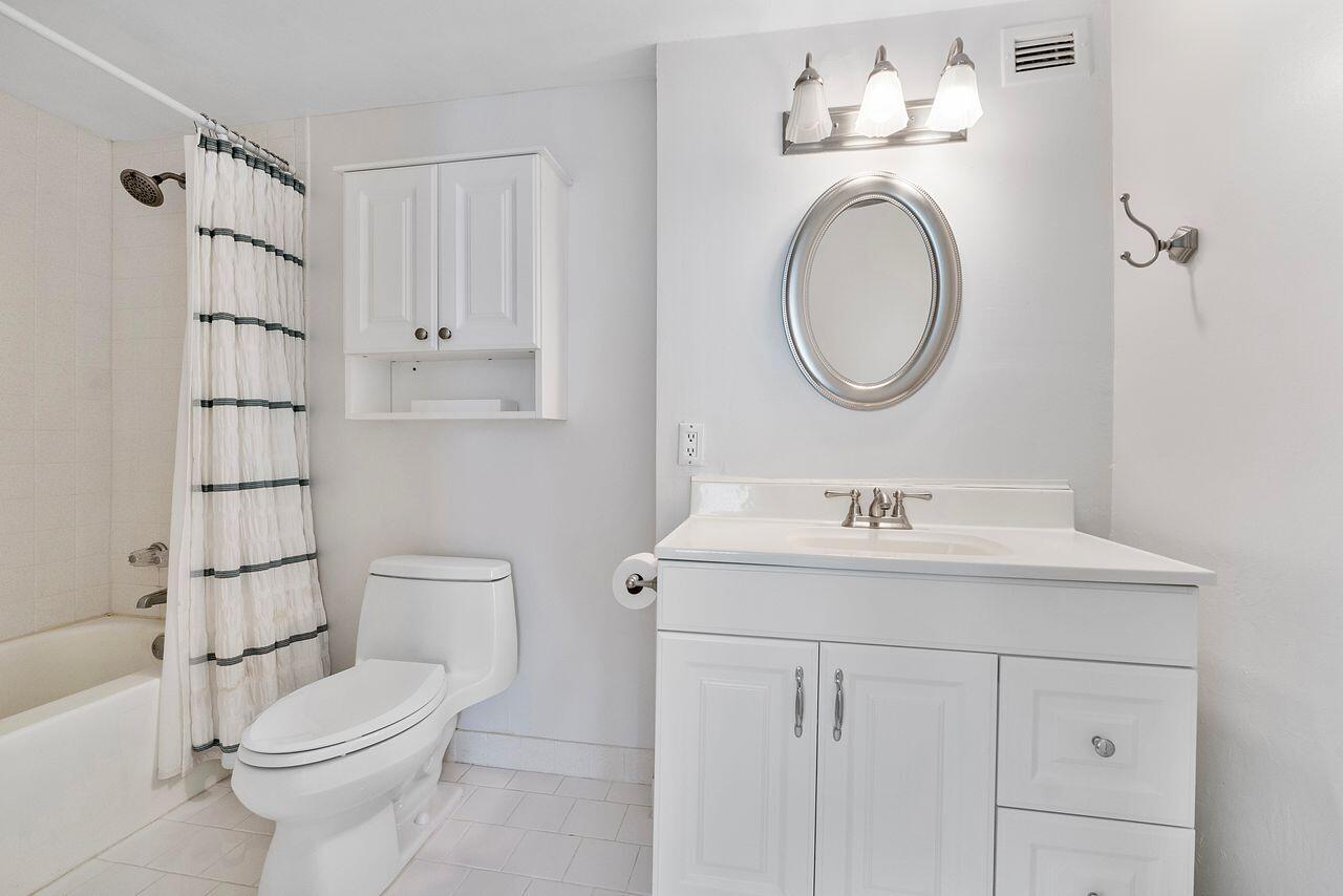 3450 South Ocean Boulevard, Unit 118 Palm Beach, FL 33480 - Photo 12 of 39 a bathroom with a sink a toilet and a mirror