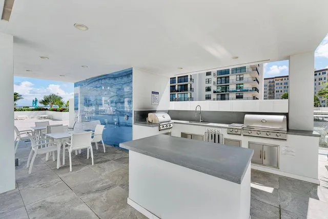 a living room with couches a coffee table and a bookshelf with wooden floor