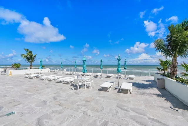 a view of a lounge chair and tables in the patio