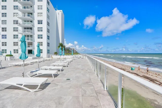 a view of swimming pool with outdoor seating and city view