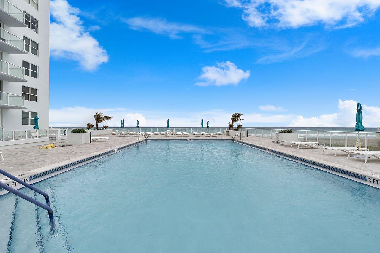 3450 South Ocean Boulevard, Unit 118 Palm Beach, FL 33480 - Photo 34 of 39 a view of a swimming pool and an outdoor seating