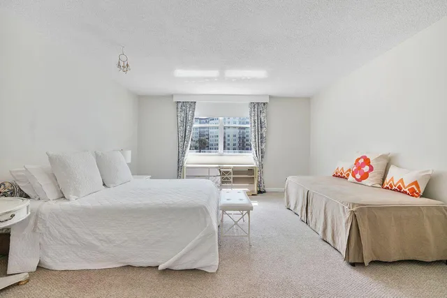 a bedroom with a bed and a table