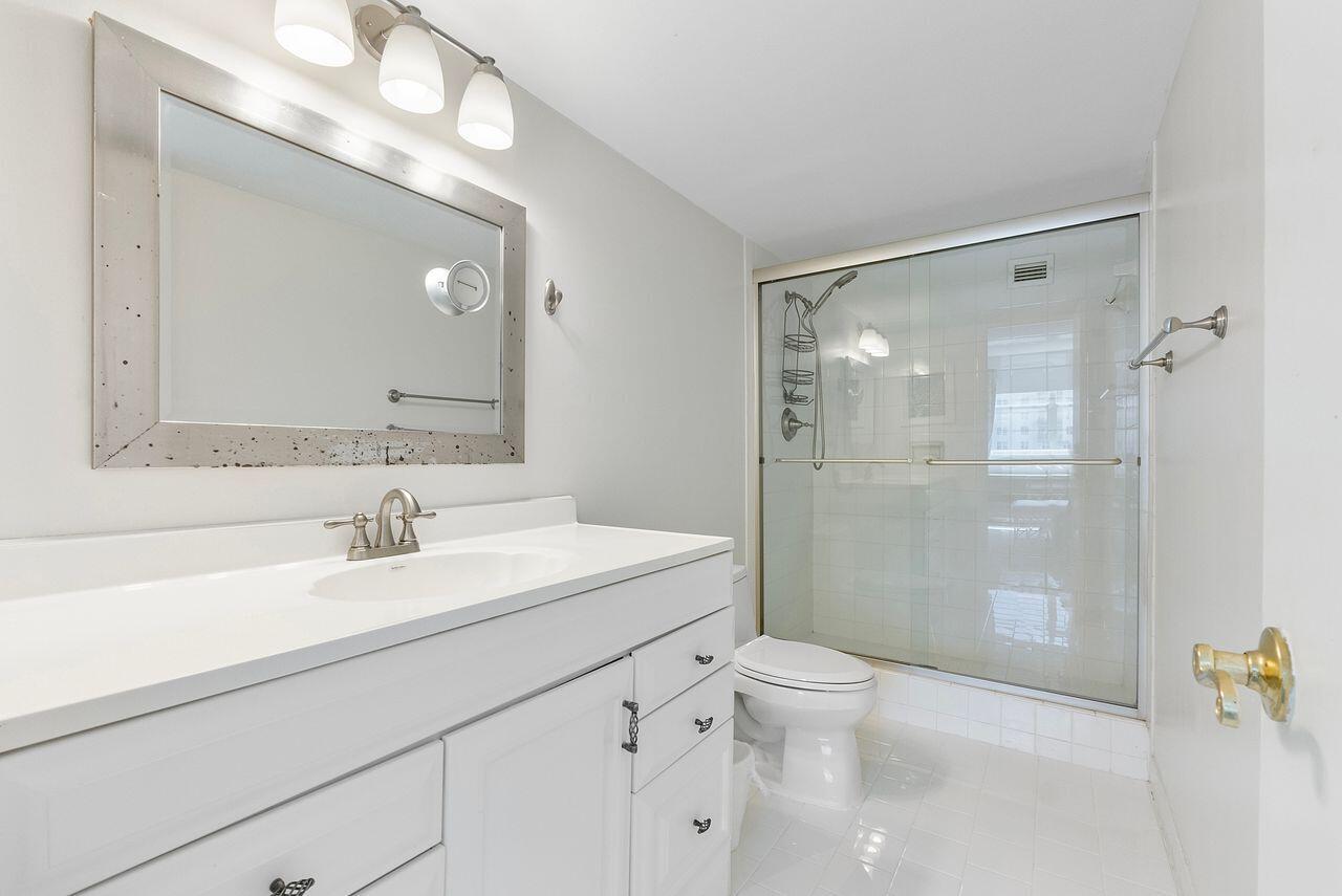 3450 South Ocean Boulevard, Unit 118 Palm Beach, FL 33480 - Photo 7 of 39 a bathroom with a sink a toilet and shower