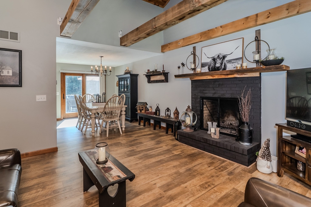 2 Gulf Road Pelham, MA 01002 - Photo 18 of 38 a living room with furniture a fireplace and a flat screen tv