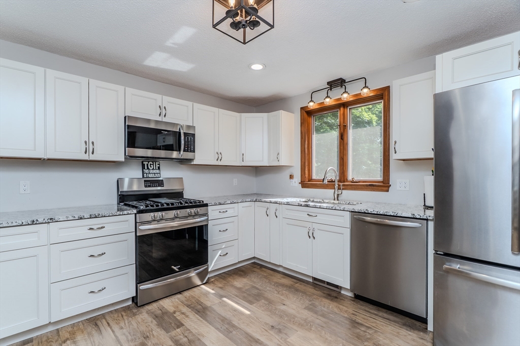 2 Gulf Road Pelham, MA 01002 - Photo 22 of 38 a kitchen with stainless steel appliances granite countertop a sink a stove a refrigerator and cabinets