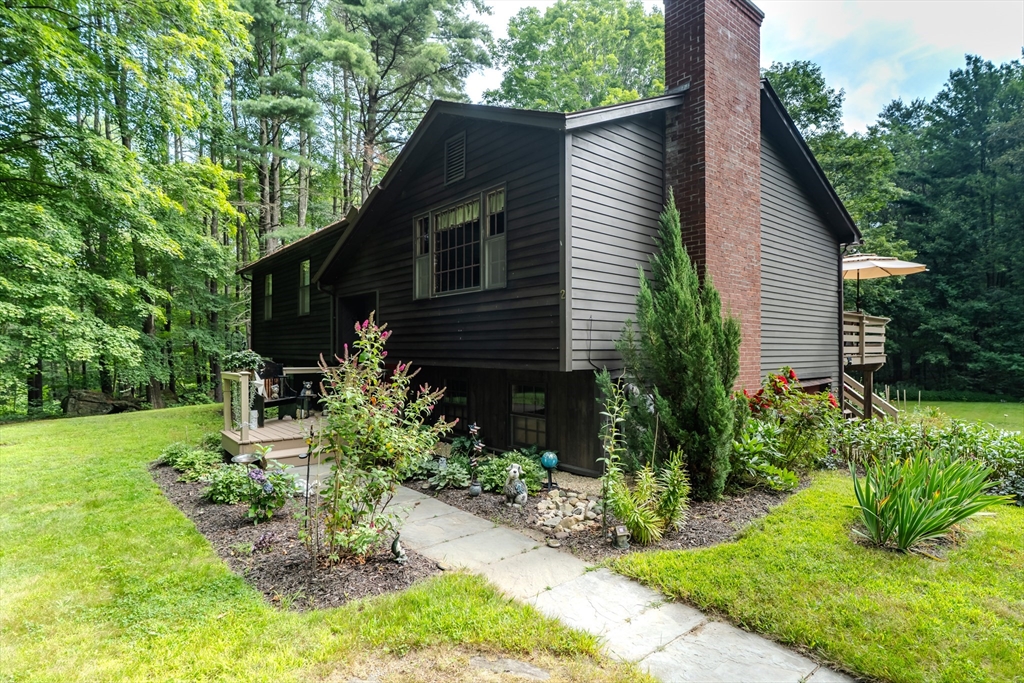 2 Gulf Road Pelham, MA 01002 - Photo 3 of 38 a backyard of a house with plants and large tree