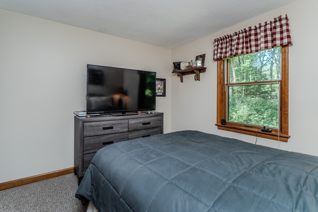 2 Gulf Road Pelham, MA 01002 - Photo 34 of 38 a bedroom with a bed and a flat screen tv