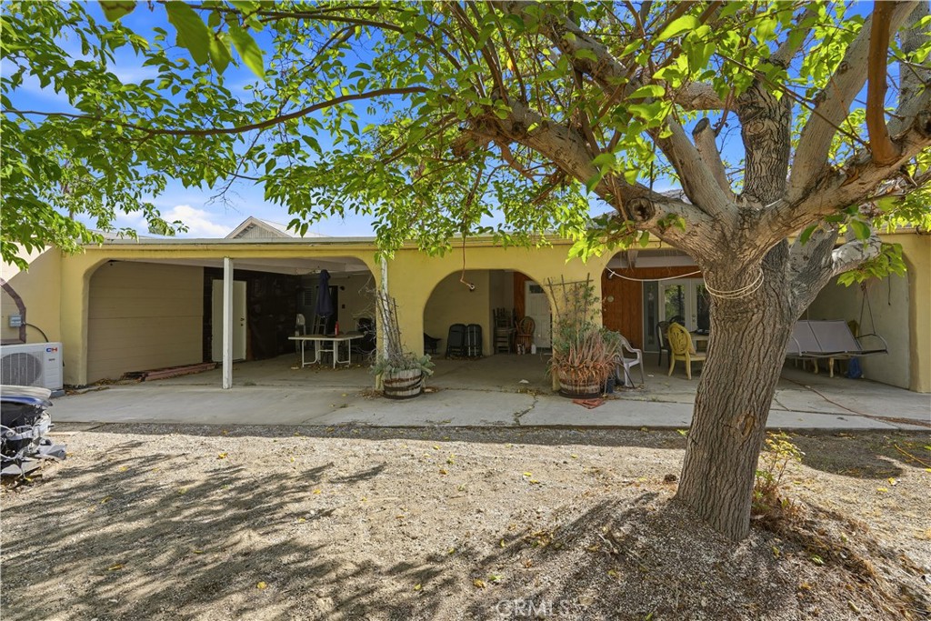 8235 Soledad Canyon Road Acton, CA 93510 - Photo 6 of 16 a view of a house with large tree and wooden fence