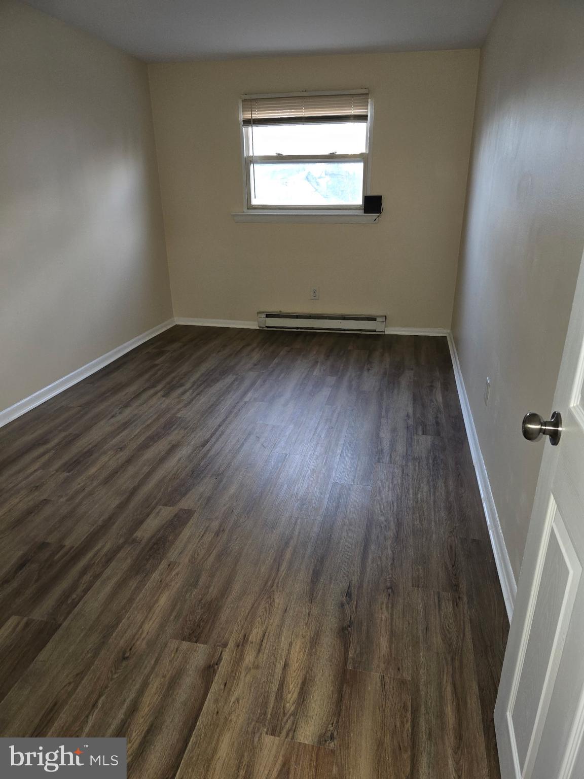 94 Governor Printz Boulevard, Unit 8 Claymont, DE 19703 - Photo 16 of 17 a view of a room with wooden floor and window