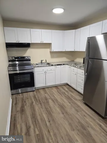 a kitchen with granite countertop a stove and a refrigerator