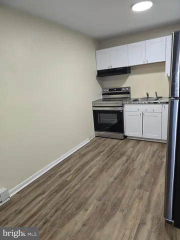 a kitchen with granite countertop a stove and a refrigerator