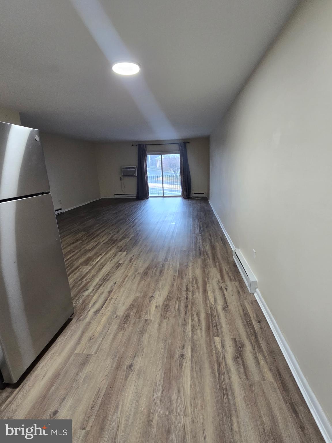94 Governor Printz Boulevard, Unit 8 Claymont, DE 19703 - Photo 8 of 17 a view of empty room with wooden floor and window