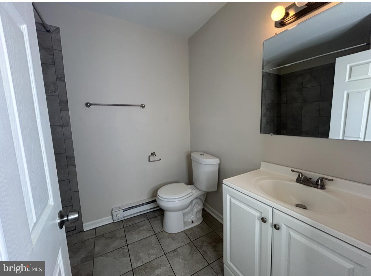 94 Governor Printz Boulevard, Unit 8 Claymont, DE 19703 - Photo 9 of 17 a bathroom with a toilet sink and mirror