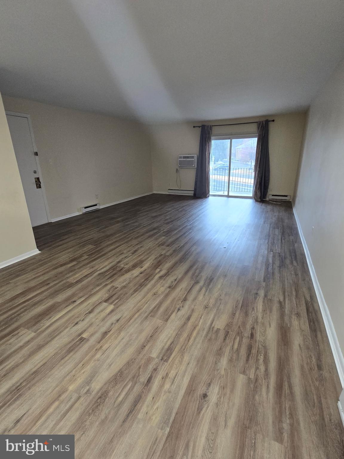 94 Governor Printz Boulevard, Unit 8 Claymont, DE 19703 - Photo 10 of 17 wooden floor in an empty room with a window