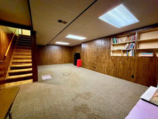 a very nice looking room with wooden floor and stairs