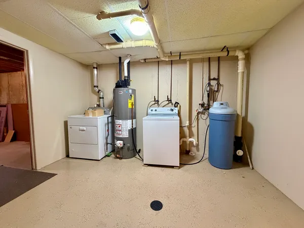a view of a storage & utility room with two washing machine