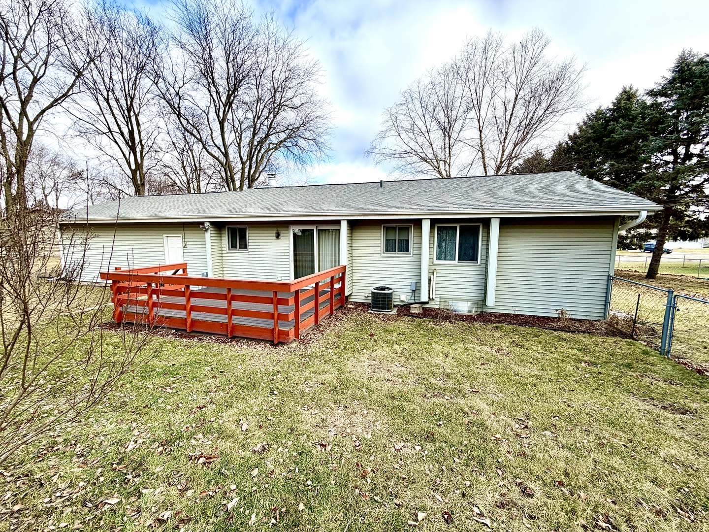 1211 Monroe Street Pecatonica, IL 61063 - Photo 2 of 19 a backyard of a house with wooden fence and large trees