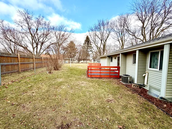 a backyard of a house with oven and tree