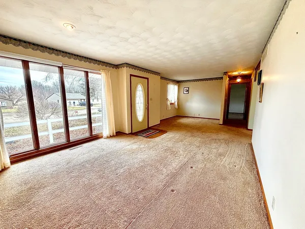 a view of a livingroom with an empty space and balcony
