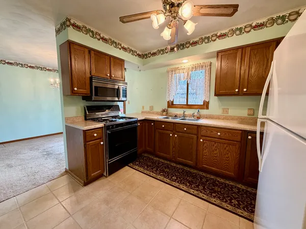 a kitchen with stainless steel appliances granite countertop a stove microwave and cabinets