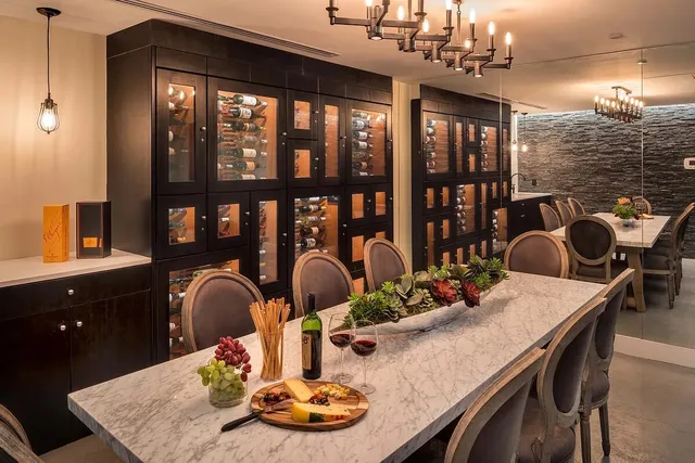 a dining room with furniture a chandelier and wooden floor